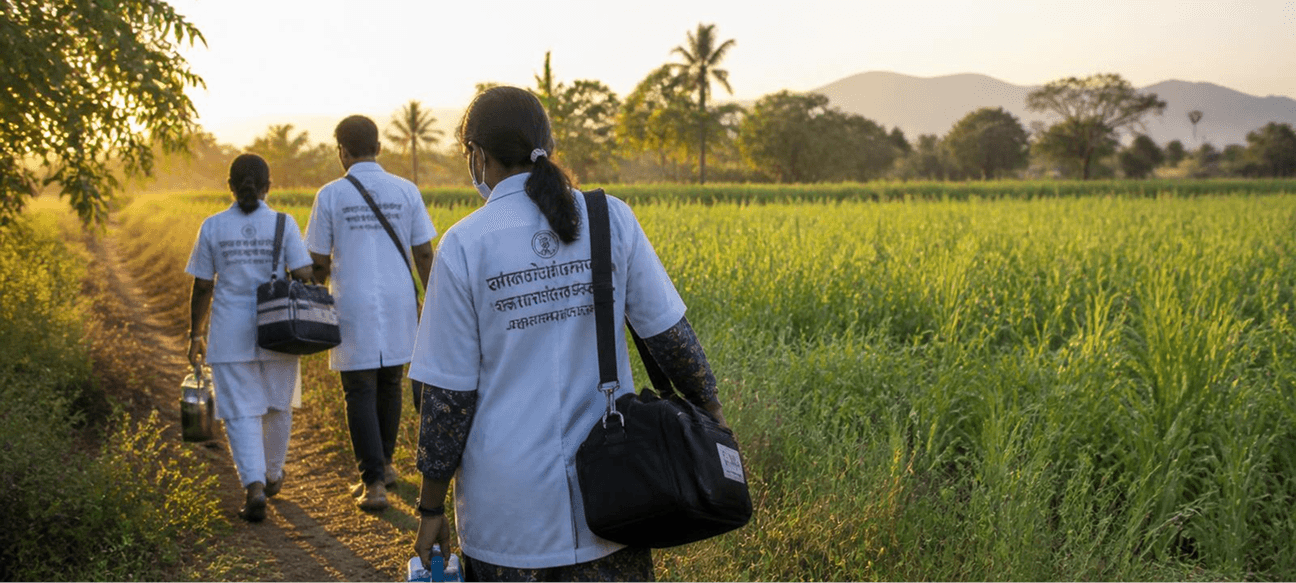 Health workers walking to a village through the fields